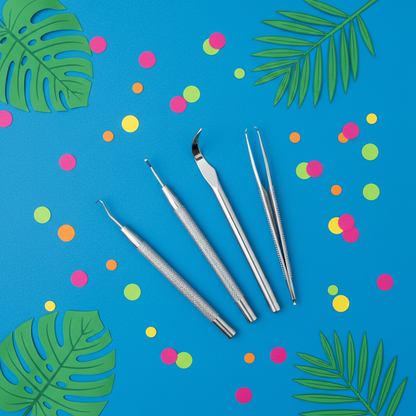 Skincare tools on cobalt blue background with tropical leaves
