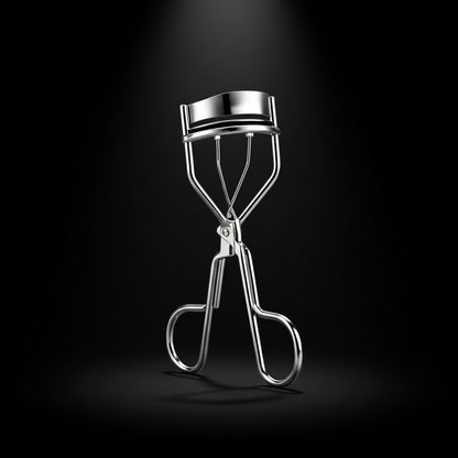 Eyelash curler – dramatic black background editorial